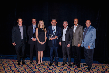 Receiving the award from Motorcar Parts of America from the left are Brent Bass, category manager; Ron Bernstein, vice president, merchandising; Jamie Cook, vice president, sales; Selwyn Joffe, chairman, president and chief executive officer; Peter Murnen, vice president, marketing; David Tobin, sales manager; and Robin Leonard, sales representative.