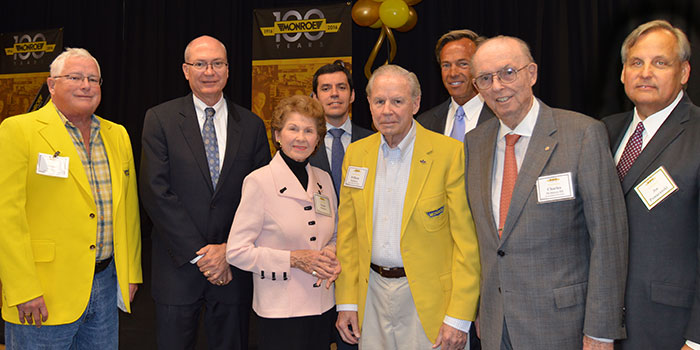 Grandsons of Monroe founders and Tenneco execs pose for a celebratory photo. From left to right: James McIntyre, Gregg Sherrill, Susan McIntyre, Enrique Orta, William McIntyre, Rick Meyer, Charles McIntyre and Joe Pomaranski.