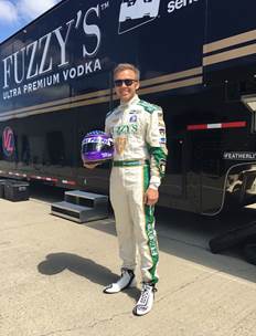 Royal Purple sponsored Indy 500 driver Ed Carpenter holds the one-of-a-kind Royal Purple designed racing helmet that will be given to the Royal Purple Indy 500 sweepstakes winner, Aaron Lewis of Louisville, Kentucky. Photo Credit: Royal Purple